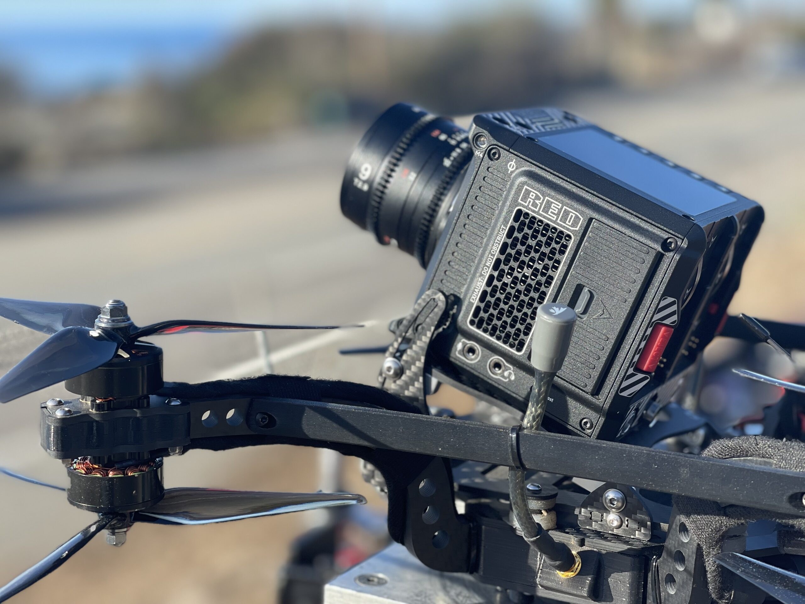 Cinema camera mounted underneath a drone, seen close up